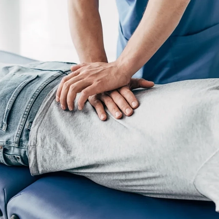 A chiropractor adjusting a patients back.