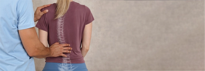Chiropractic Bellevue WA Posture A chiropractor inspecting a patients spinal alignment.