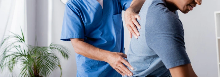 Chiropractic Bellevue WA Upper Back Exam A chiropractor placing his hands on a patients upper back.